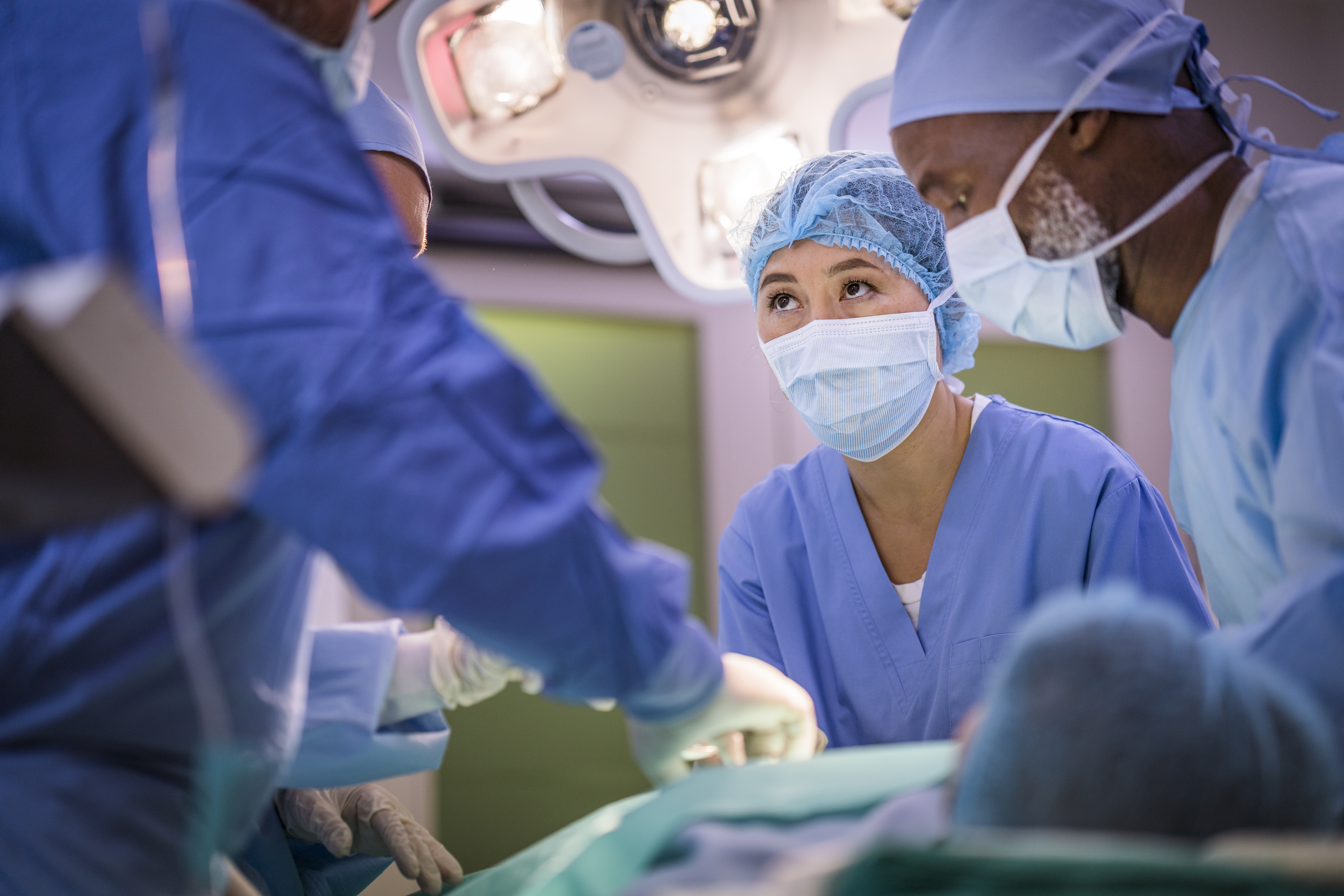 Medical colleagues performing surgery at hospital