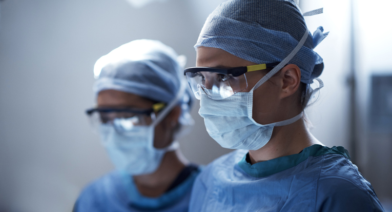 Shot of a surgeon in an operating room with her assistant in the background